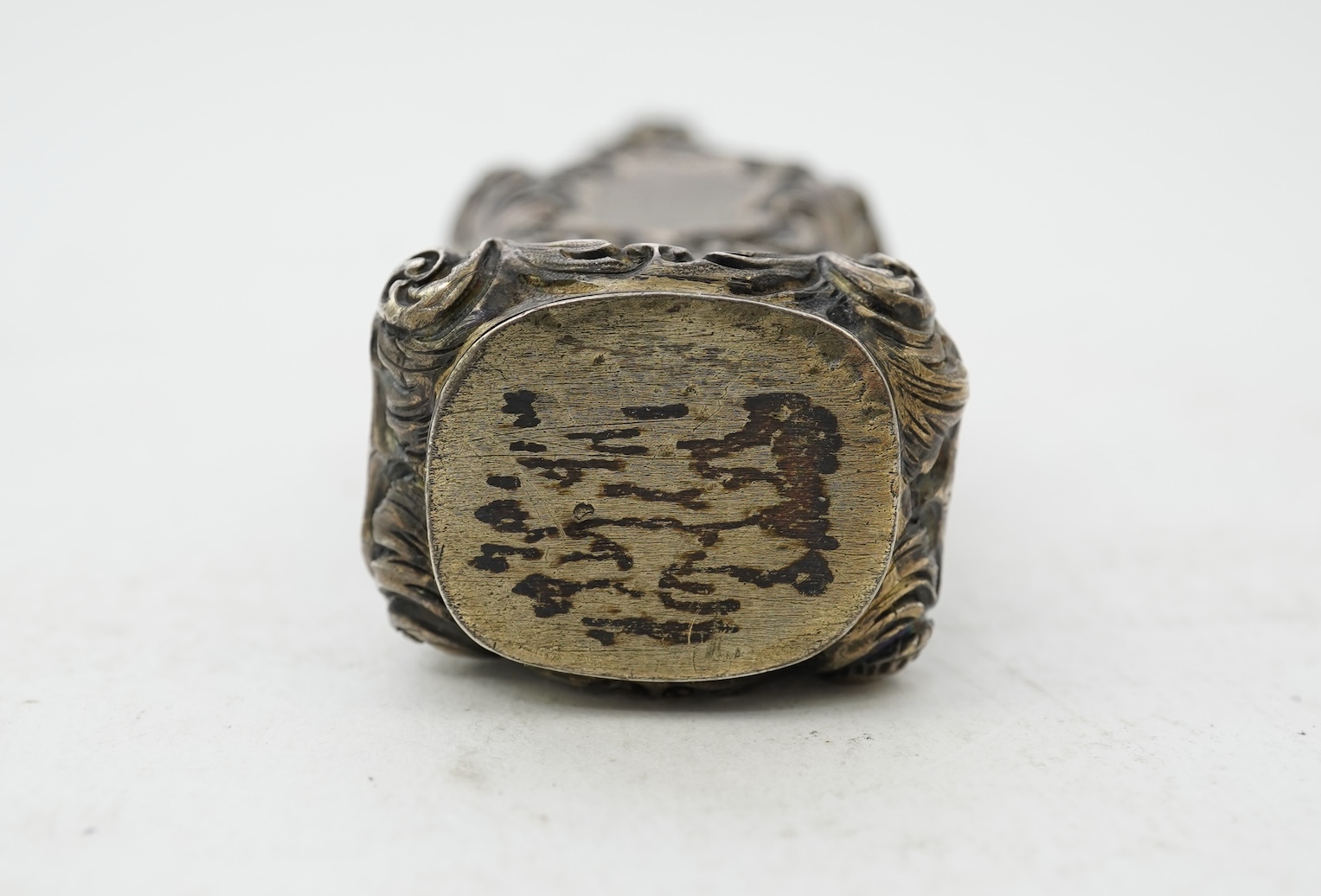 A 19th century French ornate parcel gilt white metal scent flask, with hinged cover and glass stopper